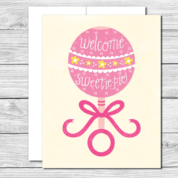 Welcome sweetie pie! Hand drawn pink rattle greeting card